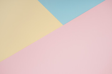 Obraz premium Abstract geometric color paper background. Minimalistic shapes and lines in pastel rose, blue, yellow colours. Copy space backdrop for your design or text, wedding greeting, postcard, brochure