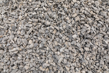 Grey crushed pebbles, background image. Crushed stone texture