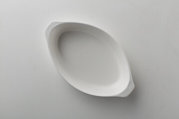 Top view shot of an oval plate on white background.