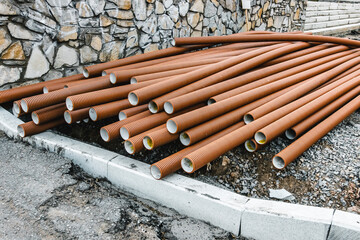 building materials bricks and pipes lie on the ground near the construction site
