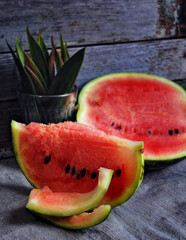 food photography of ripe, fresh summer watermelon, sliced, with juicy red pulp close-up, on a gray rustic wooden background, front view