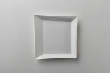 Top view shot of a squarish plate on white background.