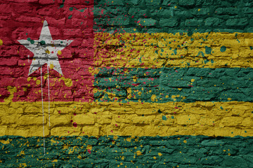 painted big national flag of togo on a massive old brick wall