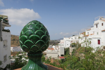 green ceramic decoration on a wall with a view on Competa