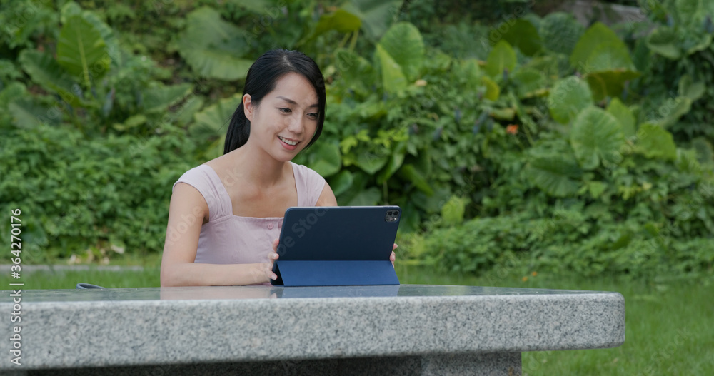 Canvas Prints Woman work on tablet computer at park