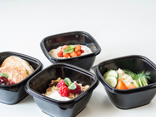Healthy breakfast delivery. Fitness food. Eat right concept, healthy food, clean food take away in boxes, fried egg and vegetables, oatmeal, granola, cheesecakes