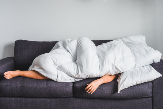 Young white woman on modern grey couch