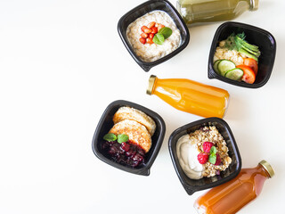 Healthy breakfast delivery. Fitness food. Eat right concept, healthy food, clean food take away in boxes, fried egg and vegetables, oatmeal, granola, cheesecakes and various smoothie on table