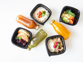 Healthy breakfast delivery. Fitness food. Eat right concept, healthy food, clean food take away in boxes, fried egg and vegetables, oatmeal, granola, cheesecakes and various smoothie on table