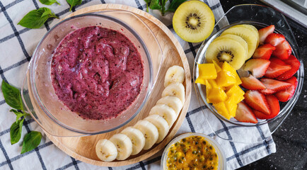 Top View. Bowl of Acai Berry and Mixed Berry Smoothie Ice Cream, with Fresh Healthy Fruits Salad