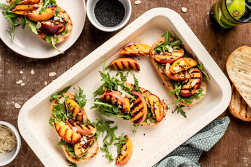 Grilled vegetarian baguette  sandwiches with arugula, grilled peach, black sesame and almond