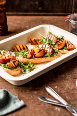 Grilled vegetarian baguette  sandwiches with arugula, grilled peach, black sesame and almond