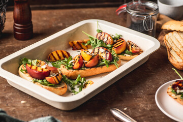 Grilled vegetarian baguette  sandwiches with arugula, grilled peach, black sesame and almond