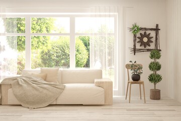 White living room with sofa and summer landscape in window. Scandinavian interior design. 3D illustration