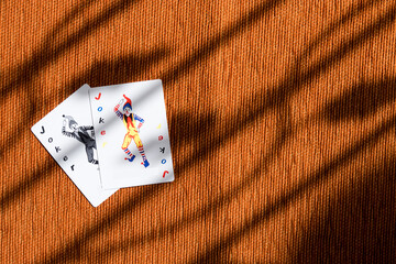 Joker card on orange background.