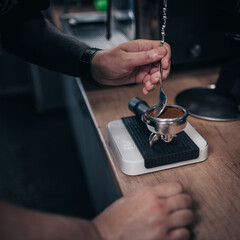 Close-up of a professional barista brewing aromatic strong coffee under pressure - fresh morning cappuccino and espresso