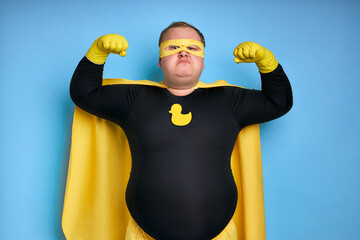 fat funny superhero will defeat everyone, man shows his power and strength, his muscles can be...