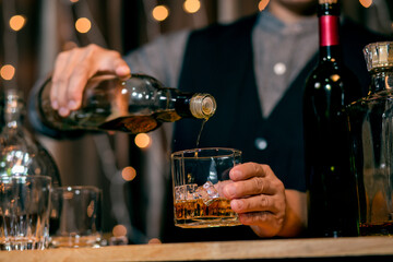 Barman pouring whiskey whiskey glass beautiful night