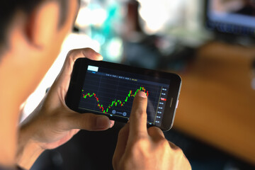 Men holding mobile phones to trade stock market.
