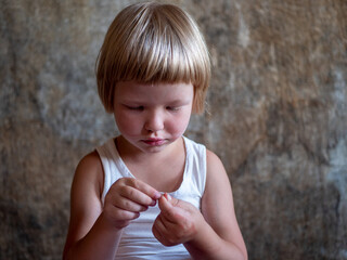 little fair-haired boy is smeared with blood. baby has weak vessels in nose bursting with pressure...