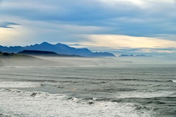  cloud sky at the beach of San Vicente de la Barquera in Cantabria with ocean view