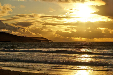 dramatic sunset sky at the beach of San Vicente de la Barquera in Cantabria with ocean view