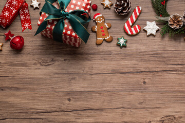 Handmake gingerbread cookies, christmas decor and gift box on wooden background. Top view. Copy space. 