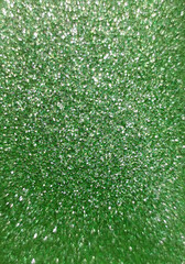 abstract green texture with glitter and shiny elements, artificial skin for the background, selective focus, noise filter, blurred background