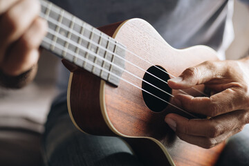 Close up Young man playing ukulele