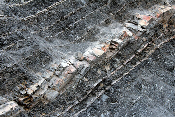 Background of black rough rocks in open pit mine