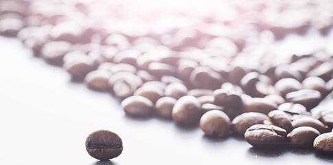 Coffee beans with green leaves for cooking. Bag of coffee. Coffee beans roasted on the table.