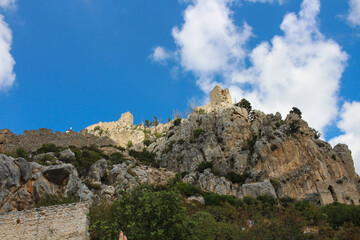 Fototapeta na wymiar View from below of the sunlit towers of the castle of Saint Hilarion. Cyprus.