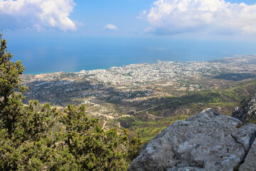 View from the wall of the castle of Saint Hilarion on the city of Kyrenia, clouds and the Mediterranean sea. Cyprus.