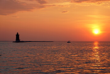 Fototapeta premium Silhouette of the lighthouse during sunset at Cape Henlopen State Park, Lewes, Delaware, U.S.A