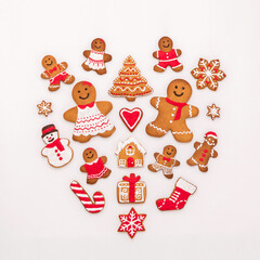 Christmas gingerbread cookies like child, tree, sock and snowflake in the shape of heart on white background.