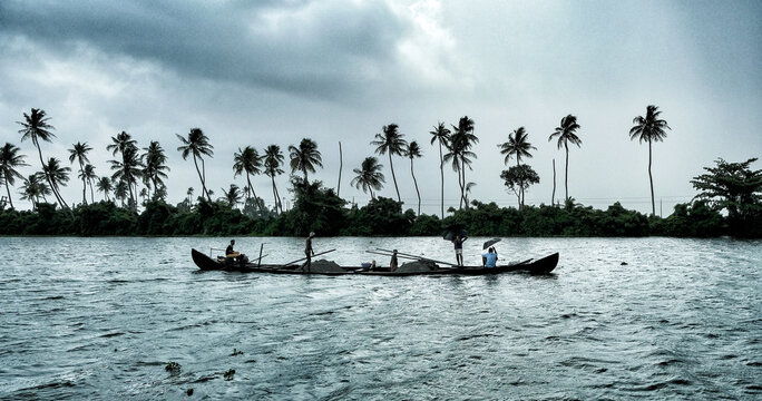 A fisherman's boat sailing the backwaters of Alleppey in Kerala. India.