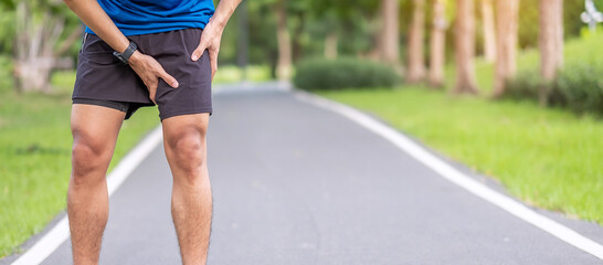 Young adult male with muscle pain during running. runner have leg ache due to Groin Pull. Sports injuries and medical concept - obrazy, fototapety, plakaty