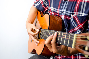 Obraz premium Close Up of Man's Hand Playing an Acoustic Guitar
