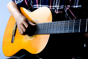 Close Up of Man's Hand Playing an Acoustic Guitar