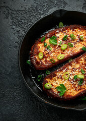 Parmesan cheese French Toast with spring onion on cast iron pan