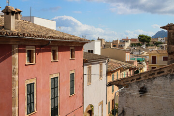 one of the streets of Alcudia on the background of a blue sky with clouds. Alcudia. Majorca. Spain.
