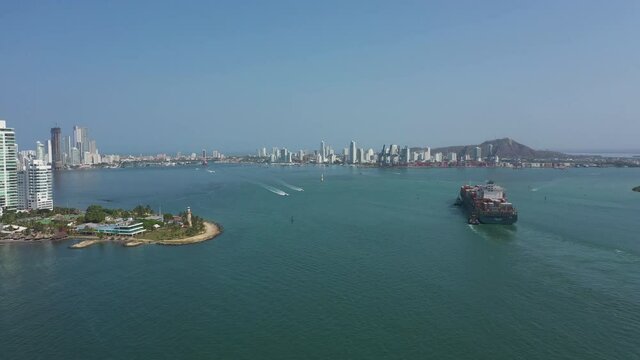 Cargo ship enters the port in Cartagena Colombia aerial view.
