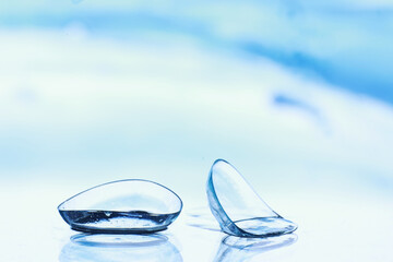 Tools for vision correction. Glasses and lenses with diopters on the background of splashes and...