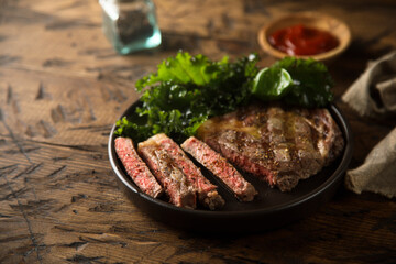 Grilled beef steak with tomato sauce