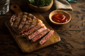 Grilled beef steak with tomato sauce