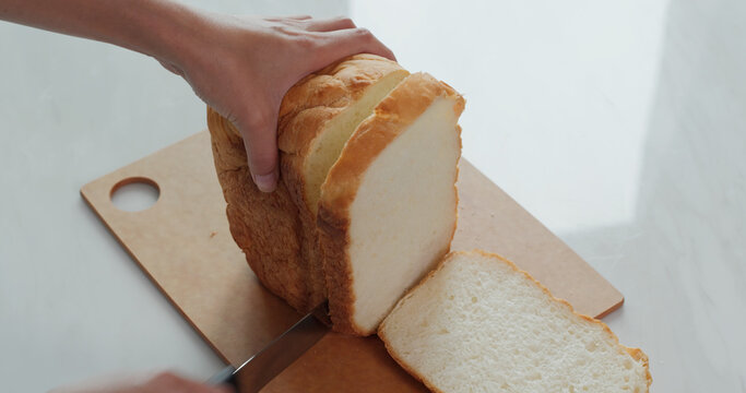Cut a white bread with knife