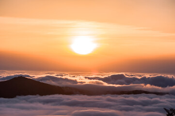 Fototapeta na wymiar Beautiful sea of clouds at sunset on the top of the mountain.