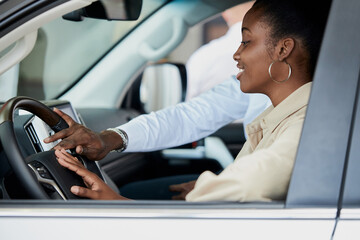 young african couple sit inside of car and discuss it before purchase, black man have conversation with wife