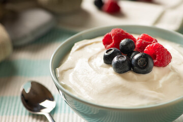 Close Up of a Healthy Breakfast in a Bowl with Fresh Yogurt, Raspberries and Blueberries