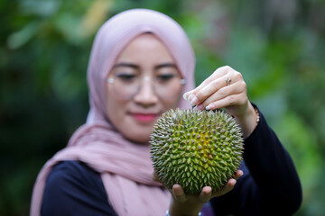 Asia woman holding durian fruit